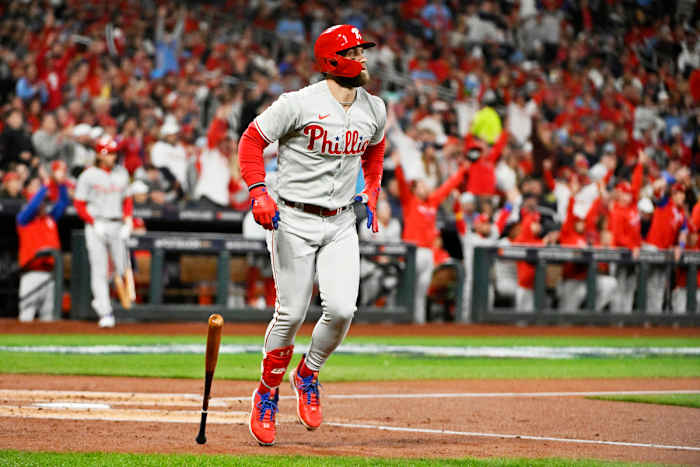Bryce Harper drops his bat and watches his go-ahead home run against the Cardinals.